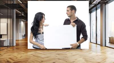 Young couple holding a blank banner - isolated  Wall mural