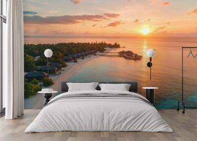 Aerial view of a tropical island with a resort at sunset. Wall mural