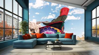 indigenous women walking dressed in typical dress made of alpaca fiber on a sunny day surrounded by clouds and a blue sky Wall mural