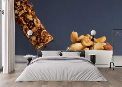 Nuts bar and mix of nuts in a white bowl. Wall mural