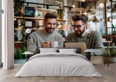 Two male entrepreneurs discussing ideas over coffee in a modern cafe Wall mural