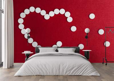 medical medicines tablets stacked on a red background in the shape of a heart Wall mural