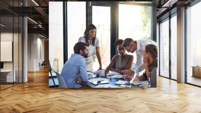 Everybody contributes on this team. Shot of a group of businesspeople having a meeting in a boardroom. Wall mural