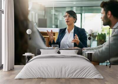 Shes got big ideas. Cropped shot of a group of businesspeople meeting in the boardroom. Wall mural