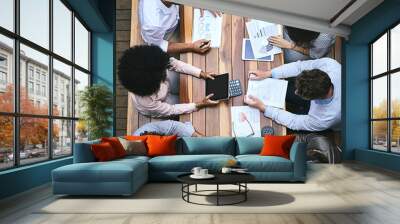 Technology helps them succeed. High angle shot of a team of businesspeople having a meeting outside. Wall mural