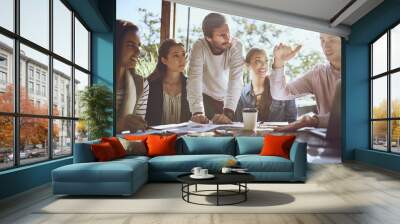 The good ideas are right in from of him. Shot of a group of colleagues having a meeting at a cafe. Wall mural