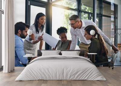 Exchanging ideas in the boardroom. Shot of a group of businesspeople having a meeting in a boardroom. Wall mural