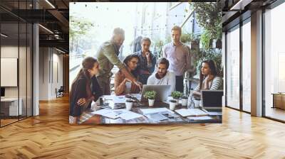 Mixing business with a breath of fresh air. Shot of a team of colleagues using a laptop together during a meeting at an outdoor cafe. Wall mural