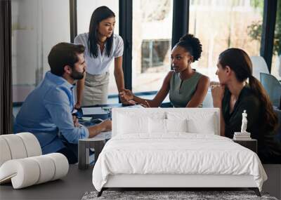 Shes bringing new ideas to the team. Shot of a group of businesspeople having a meeting in a boardroom. Wall mural