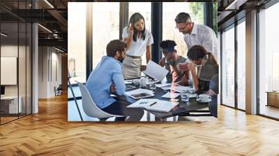 Strategy session time for the team. Shot of a group of businesspeople having a meeting in a boardroom. Wall mural