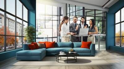 Teamwork is the quickest way to success. Shot of a group of colleagues discussing business in the office. Wall mural