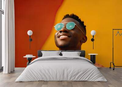 Close up portrait of a smiling young african american man wearing sunglasses over orange background. Generative AI Wall mural