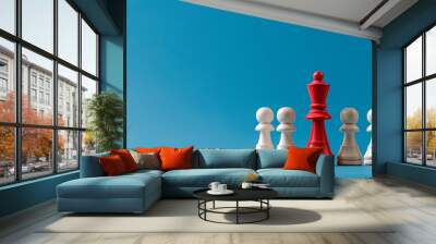 Red chess queen among white pawns on blue copy space Wall mural