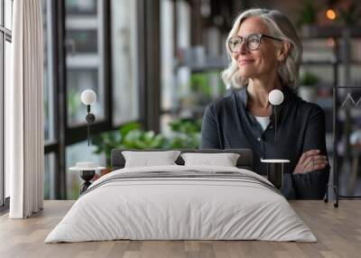 Happy mature professional business woman standing in office looking away. Smiling middle aged businesswoman, senior female corporate leader, confident lady executive manager arms crossed looking aside Wall mural