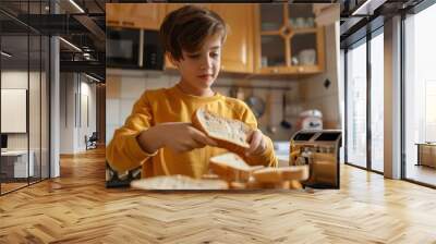 teenage boy cooking in the kitchen, holding bread slice in hand making toasts in toaster for snack preparing family breakfast or lunch alone at home. Wall mural