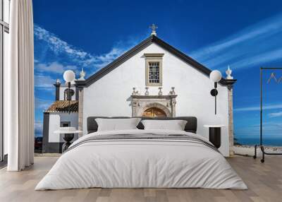 The church of Cacela Velha in southern Portugal. White facades of houses with colored decorations. Wall mural