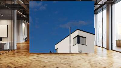 modern house facade with chimney windows balcony on blue sky Wall mural