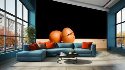 next egg to break - two eggs on table against black background Wall mural