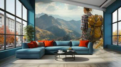 A female hiker with a backpack gazes at a breathtaking mountain landscape, embodying adventure and exploration. Wall mural