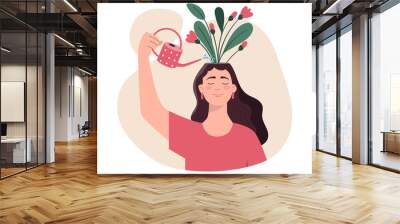 thinking positive mindset. girl watering flowers on her head with watering can. conscious woman opti Wall mural