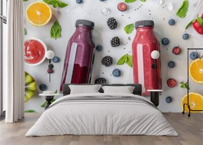 Smoothies with berries and fruits in two glass bottles on the white table Healthy drink variation and kids food Flat lay Wall mural