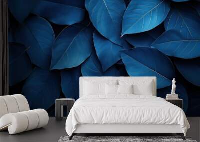 A close up of blue leaves with a dark background Wall mural