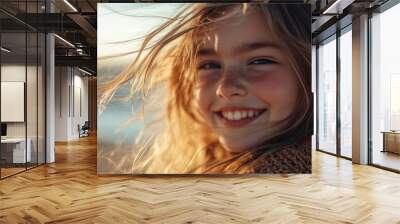 A young girl with long hair is smiling and looking at the camera Wall mural