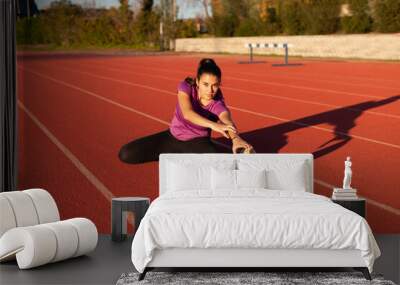 young sportsman on the running track Wall mural