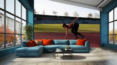 young sportsman on the running track Wall mural