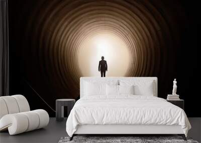 Business success and life in motion concept with man walking towards the light from wall hole in the middle of a huge dark hall with stairs Wall mural