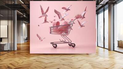 Flying shopping cart with shopping bags on a pink background Wall mural