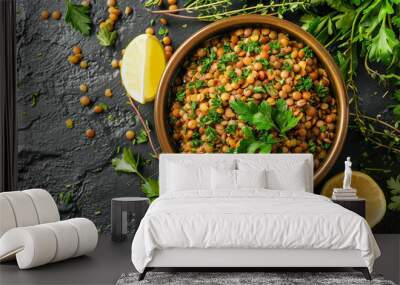 A flat lay of a bowl of cooked lentils, surrounded by fresh herbs like parsley and thyme, with a few lemon wedges placed on the side.  Wall mural