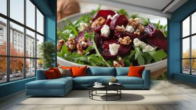 A shot of a deep red beetroot salad with crumbled goat cheese, arugula, and toasted walnuts, served in a white bowl. The earthy beets stand out against the fresh greens and creamy cheese. Wall mural