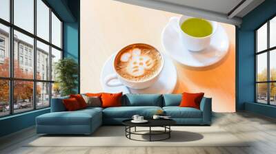 hot cappuccino coffee with green tea on table Wall mural