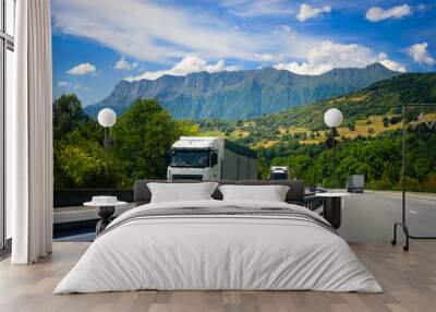 Trucks drive on the European highway on the Alpine mountains. Wall mural