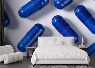 Close-up of shiny blue capsules arranged on a white background, emphasizing their color and glossy surface.
 Wall mural