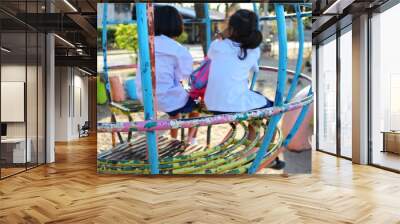  Two female students sitting on the playground, blurred images Wall mural