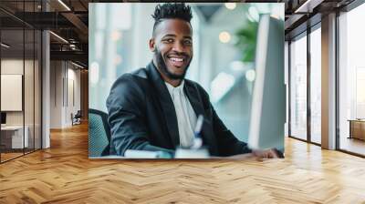 The businessman's smile conveys confidence and enthusiasm as he tackles tasks at his computer desk. Wall mural