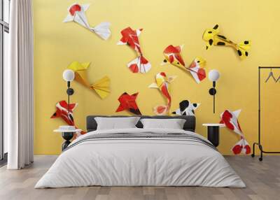 handmade paper craft origami koi carp fish on yellow background Wall mural