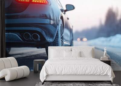 A car with winter tires carefully drives along a snowy winter road Wall mural