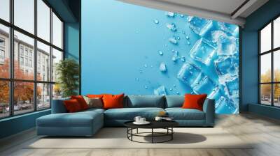 Aerial image of ice cubes and drops on blue background with space Wall mural