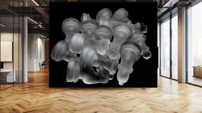 Classic glass chess pieces on a glass board. Conceptual photo on a black background. Wall mural