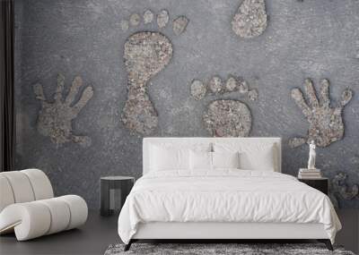 closeup footprints of a child’s feet and hands on concrete, background with blur Wall mural