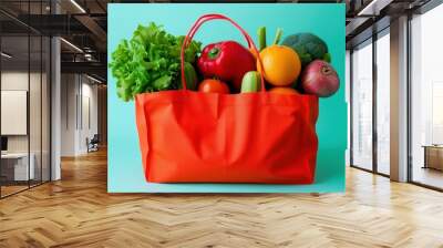 A red bag full of fruits and vegetables on a green background Wall mural