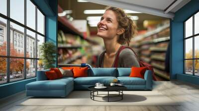 A woman is happily smiling as she shops in a grocery store today Wall mural