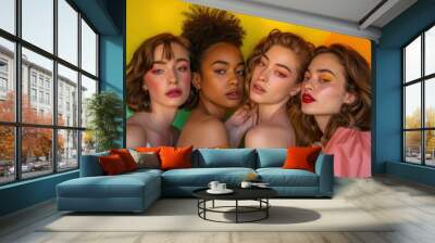 Four women stand together in front of a colorful background Wall mural