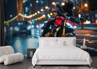 Man riding a motorcycle at night in a city. The motorcycle is red and black and the rider is wearing a black helmet. The city is in the background and is out of focus Wall mural