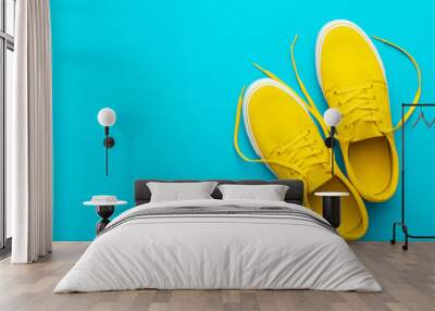 minimalist flat lay image of yellow summer footwear over blue turquoise background with copy space.  Wall mural