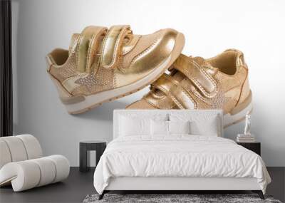 flat lay. the gold children's sports shoes isolated on a white background Wall mural