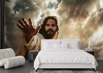 Jesus stretching out his hand against the background of thick clouds and sun rays Wall mural